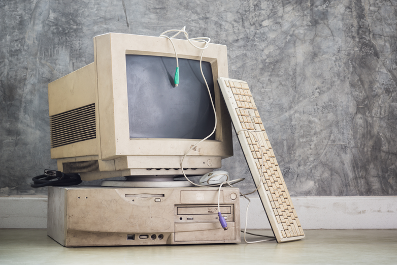 Image of vintage computer collecting dust before being updated to run faster